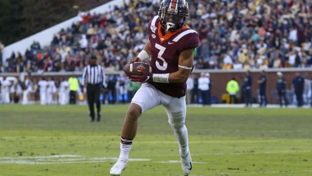 Virginia Tech Hokies defensive back Caleb Farley (3) returns an interception for a touchdown against the Georgia Tech Yellow Jackets in the second quarter at Bobby Dodd Stadium.